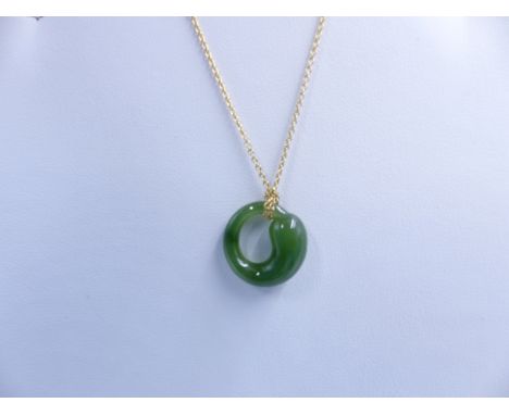 A TIFFANY & CO ETERNAL CIRCLE JADE AND 18ct GOLD ELSA PERETTI PENDANT. APPROXIMATE LENGTH 22cms. 