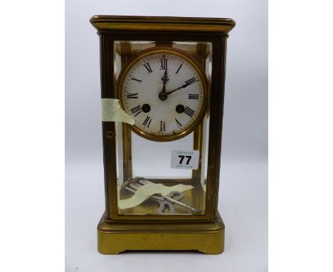 A LATE VICTORIAN/EDWARDIAN BRASS CASED FOUR GLASS TABLE CLOCK WITH 8-DAY MOVEMENT STRIKING ON BELL.   H.26cms.