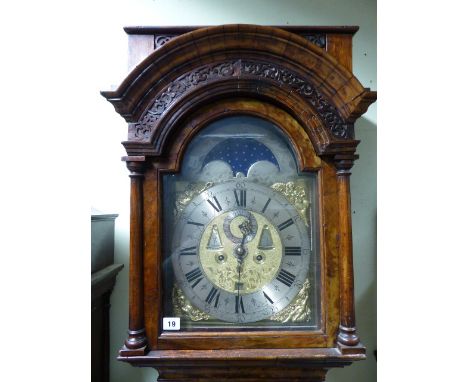 AN 18th.C.DUTCH WALNUT CASED LONGCASE CLOCK WITH FRET PANEL HOOD OVER SLENDER DOOR WITH BULLSEYE GLASS ON BROAD BOMBE BASE.  