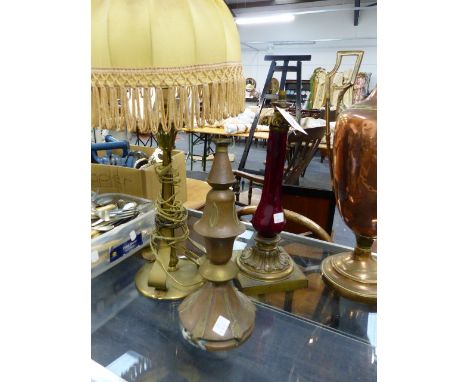 A VICTORIAN RUBY GLASS BRASS MOUNTED LAMPBASE.   H.39cms TOGETHER WITH TWO ARTS AND CRAFTS DESIGN BRASS LAMPBASES.  (3)