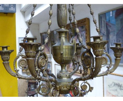 AN ANTIQUE BRASS NEO CLASSICAL STYLE SIX LIGHT CHANDELIER. URN FORM SHAFT WITH SCROLLING BRANCHES.   H.100cms.  Dia. 54cms.