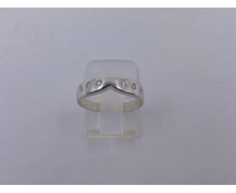 A 750 STAMPED WHITE METAL FLUSH SET DIAMOND ETERNITY RING, FINGER SIZE M, APPROXIMATE WEIGHT 3.8grms.  