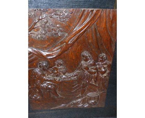 AN ANTIQUE CARVED OAK PANEL DEPICTING A ROYAL AND SERVANTS TOGETHER WITH A FRAMED EMBOSSED LEATHER PLAQUE OF CUPID AND PHSYCH