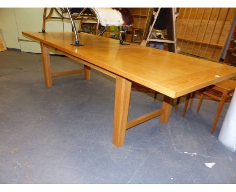 A GOOD QUALITY HEAL'S OAK EXTENDING DINING TABLE AND TWELVE LADDER BACK RUSH SEAT CHAIRS.