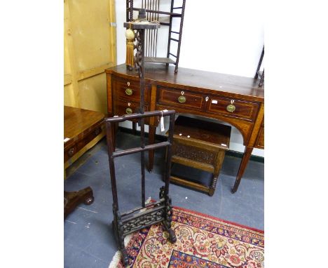 A CHINESE CARVED HARDWOOD ADJUSTABLE FLOOR LAMP WITH TRESTLE FORM BASE AND SCROLL SUPPORTS.