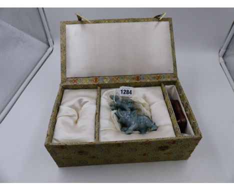 A CHINESE JADE MODEL OF AN ELEPHANT AND SHI SHI WITH PLINTH.   H.10cms. (boxed)