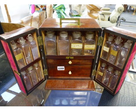 A 19th.C.MAHOGANY APOTHECARY CABINET WITH FITTED INTERIOR AND FULL COMPLIMENT  OF BOTTLES, SCALES,ETC.