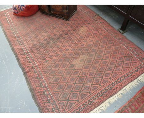 AN ANTIQUE BELOUCH RUG.   204 x 129cms TOGETHER WITH A SMALL BELOUCH RUG AND A CAUCASIAN FRAGMENT MOUNTED AS A CUSHION.