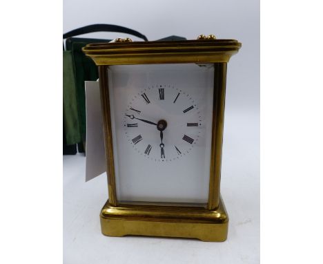 A SWISS MADE BRASS CASED CARRIAGE CLOCK WITH WHITE ENAMEL DIAL, THE SIDES WITH PICTORIAL PANELS CONTAINED IN A GREEN CLOTH CA