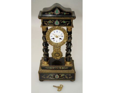 A French Empire portico clock, the gilt metal mounted ebonised wood case with vine bound barley twist columns enclosing an ei