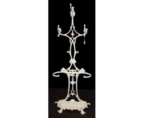 A Victorian, later refurbished cast iron coat/stick stand with three entwined scrolled branches, twin concave stick rests and