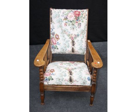 Elliston and Cavell, Oxford, an early 20th century oak ' plantation' reclining armchair with floral print upholstery