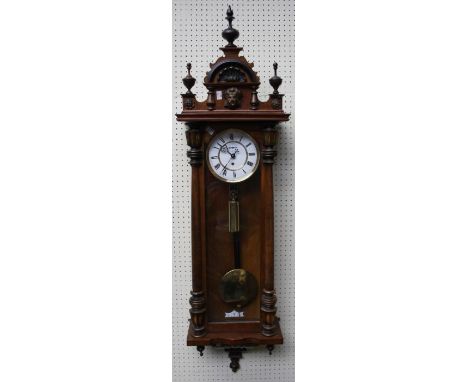 A late 19th century Vienna wall clock, the half turned column case enclosing a single train movement faced by enamel Roman di