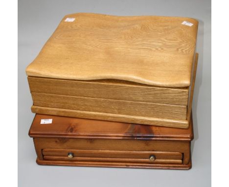 A craftsman built light oak collectors chest, the undulating adzed top rising to reveal a twelve division interior, above sim