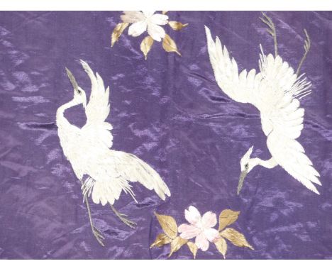 An Oriental silkwork panel decorated with birds and flowers