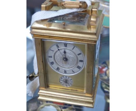 An Edwardian gilt brass cased carriage clock with alarm