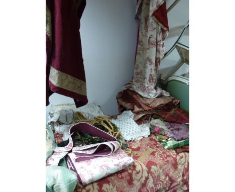 A collection of various curtains, cushions, pieces of fabric etc