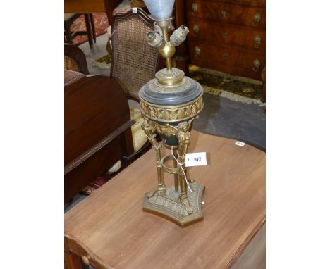 A gilt and patinated bronze urn with winged caryatid supports mounted as a lamp