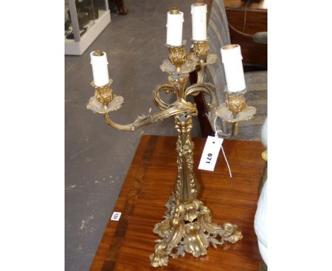 A gilt bronze four light candelabrum in the rococo taste mounted as a lamp