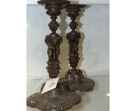 A pair of Antique bronze French candlesticks decorated in the Renaissance revival manner