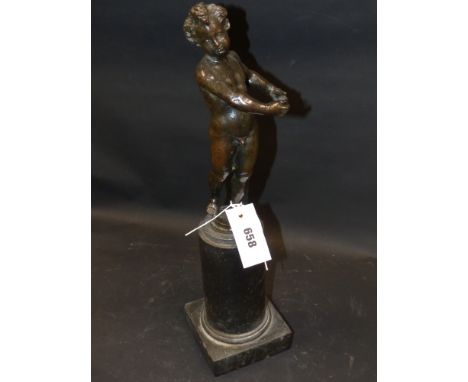 An early bronze figure of a standing Putto on black marble base, possibly Italian