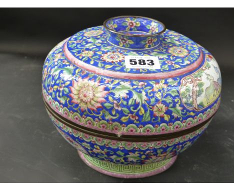 A Chinese enamel covered footed bowl. Panels of animals and birds surrounded by flower filled blue ground