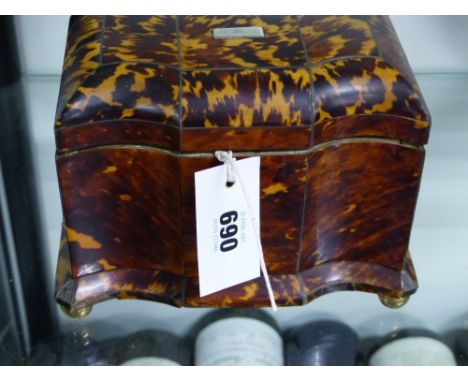 An early Victorian tortoise shell two compartment tea caddy of shaped form