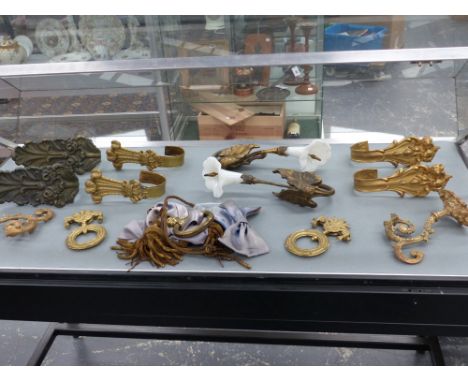 A group of 19th century bronze and ormolu curtain tie-backs and pull handles etc.