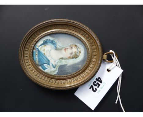 A 19th Century oval watercolour miniature portrait of a young lady. Empire style brass frame