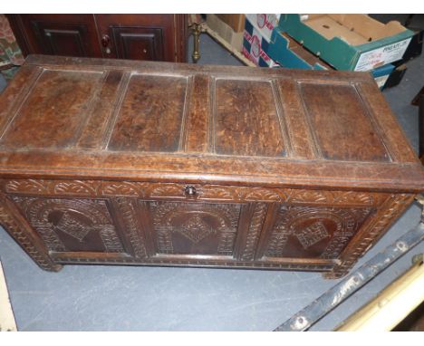 An 18th.C.Oak panel chest with carved panels and frieze