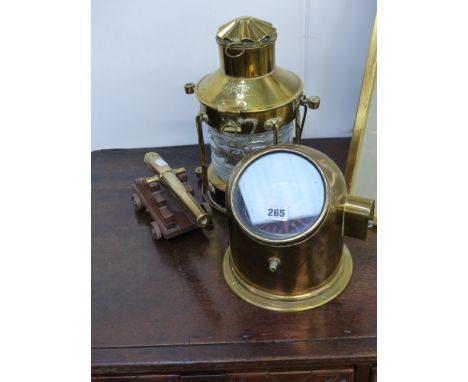 A ship's compass, an anchor light and a model cannon