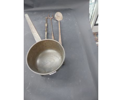 An early bronze trifid footed skillet together with three iron utensils