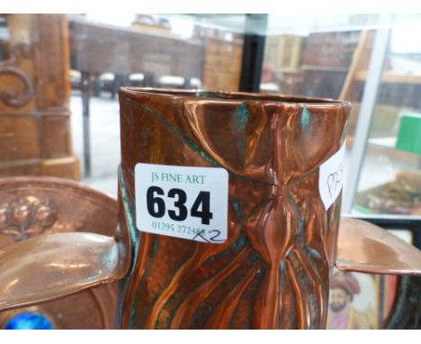 An arts and crafts newlyn school copper tall vase with embossed decoration together with a similar period copper small charge