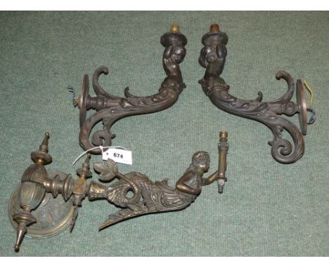 A pair of bronze figural wall lights, and another similar (electrified former gas lights)