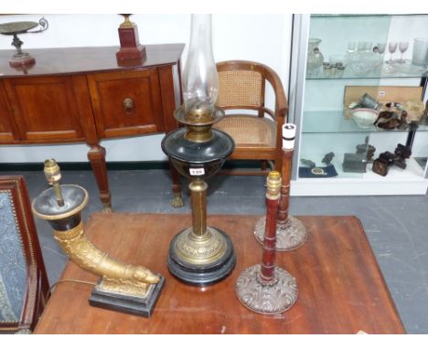 A Victorian oil lamp with green glass reservoir and three further lamps