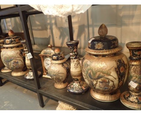 Eight pieces of Oriental ceramics including two large lidded jars four candlesticks a clock and a small lidded jar