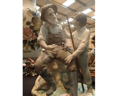 Large Lladro Grandad with Boy fishing H: 27 cm CONDITION REPORT: No cracks, chips, or visible restoration however the wooden 