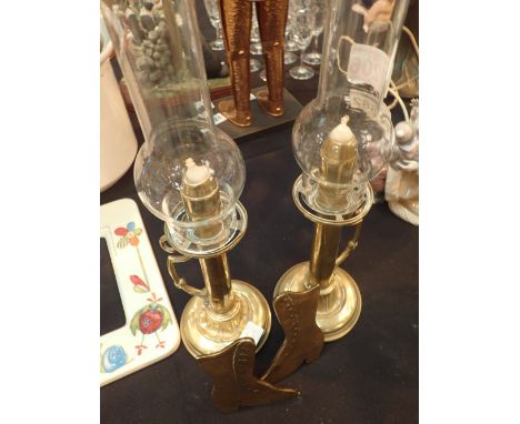 Pair of Art Nouveau style candlesticks with glass chimneys and a pair of brass boots