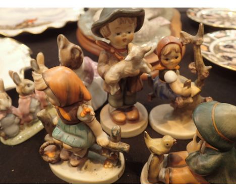 Three Goebel figurines and two Beswick Beatrix Potter figurines