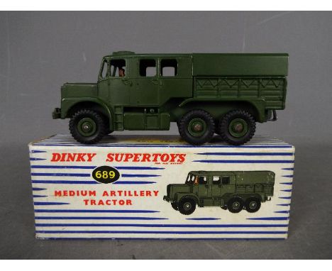 Dinky - A boxed # 689 Medium Artillery Tractor in Very Good condition with only very light signs of play use in a Good box wi