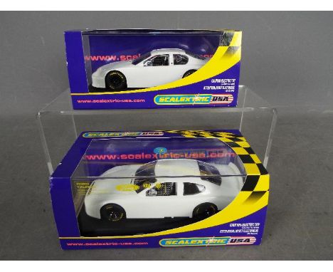 Scalextric USA - two 1:32 scale models comprising #C2605 Chevrolet Monte Carlo Plain White and #2604 Ford Taurus Plain White,