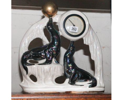 1950's mantel clock depicting sea lions in a lustre case