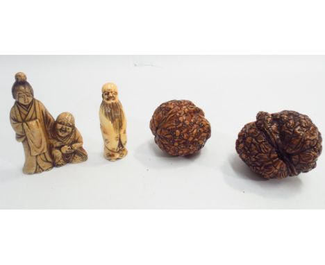 Oriental marine ivory carved netsuke of a man and woman, another of a Sage with long beard and 2 carved walnuts 