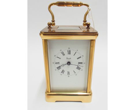 Good quality brass cased carriage clock with key, retailed by Harrods - measures 19 cm tall