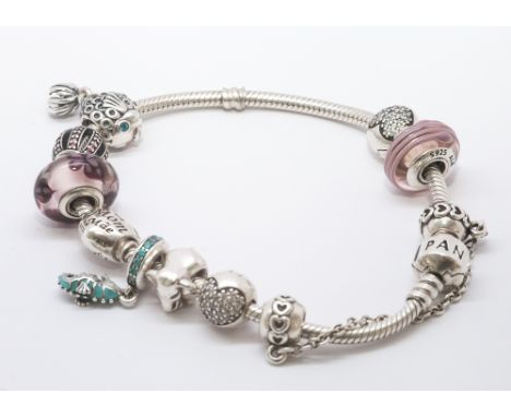 Silver Pandora bracelet, set with 9 various beads and a silver safety chain spacer, in original box