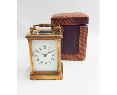 Small French brass carriage clock with key and leather carry case - measures 12 cm tall with handle up 