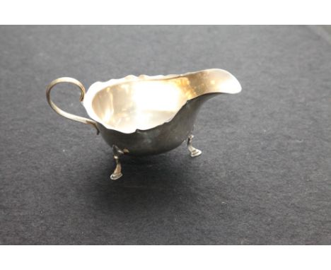 Silver sauce boat, silver cream jug and a silver sugar basin. Gross weight of three items -  8 oz troy