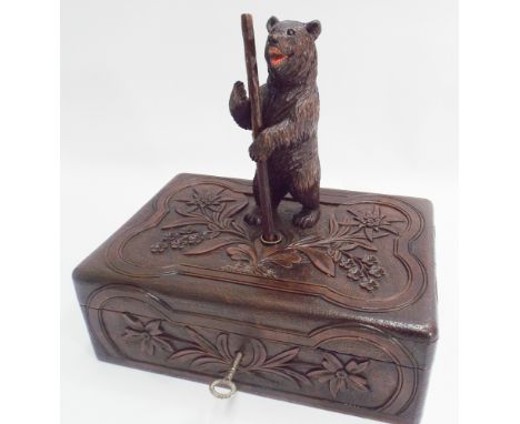 Black forest carved bear locking trinket box, the top mounted with black forest bear holding a staff, could be used as a pen 