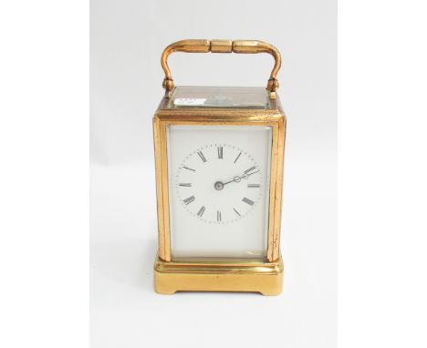French gilt brass carriage clock with key with full glass aperture to top - measure 17 cm with handle up