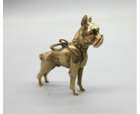 9ct yellow gold boxer dog charm set with ruby eyes, stamped 375, approx. L3cm, 8.2gShipping £20.00 plus vat (UK Only)